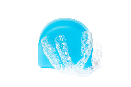 Invisible braces and blue box on white background, dental orthodontic transparent health equipment