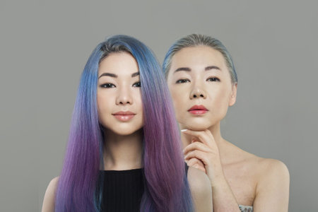 Beautiful Asian women, young adult and senior. Aging, cosmetology, plastic surgery and retouching before and after conceptの写真素材