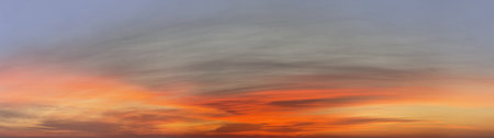 Panoramic sunset sky with red, gold and blue color clouds, beautiful nature background