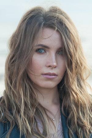 Closeup portrait of young adult model woman brunette with long wavy hairstyle and natural make-up, fashion beauty outdoor portraitの写真素材