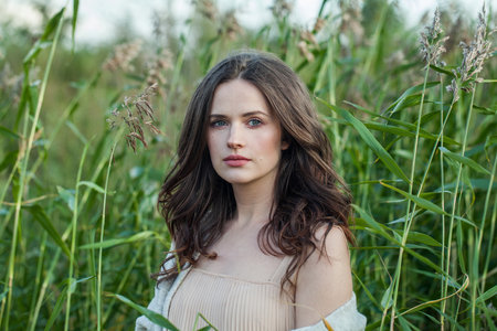 Cute healthy brunette woman with long hairstyle and fresh skin walking outdoorsの写真素材