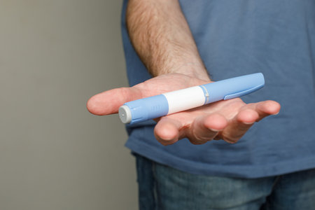 Semaglutide Injection Diabetes Drug Being Used For Weight Loss in male hand closeup on background with copy spaceの写真素材