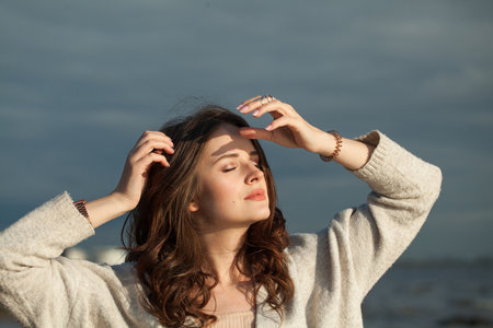 Resting healthy brunette woman with long hairstyle and fresh skin walking outdoorsの写真素材