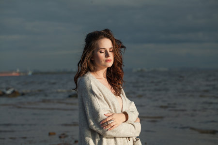 Relaxing healthy brunette woman with long hairstyle and fresh skin walking outdoorsの写真素材
