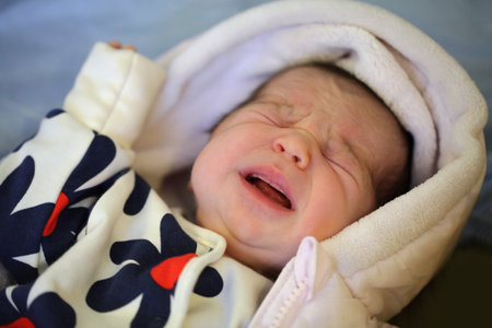 Crying baby newborn. Little baby indoor portraitの写真素材