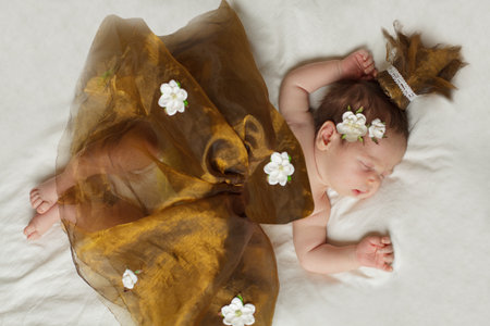 Beautiful newborn baby girl. New born child princess sleeping on white backgroundの写真素材