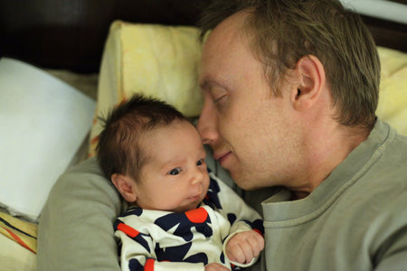 Cute newborn baby in fathers hands