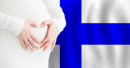 Demographics, pregnancy and love baby in Finland concept. Pregnant woman making heart against her stomach on Finnish flag background.の写真素材