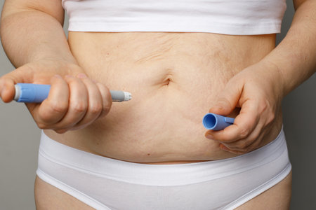 Woman injecting insulin with insulin penの写真素材