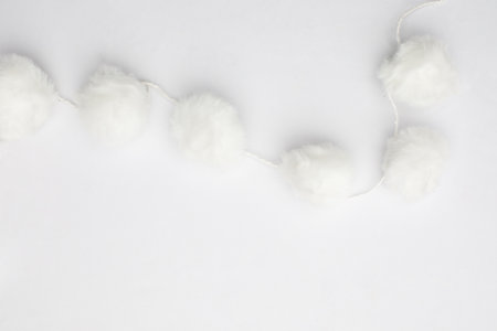 White pom pom decoration garland border on white backgroundの写真素材