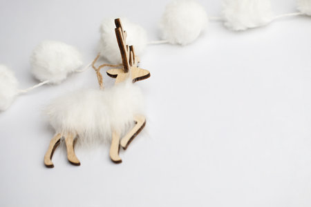 Christmas card with white deer decoration on white backgroundの写真素材