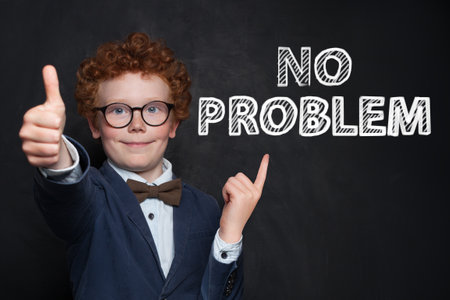 Successful happy child boy portrait on black backgroundの写真素材