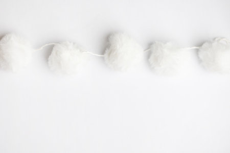 Minimal white background with pom pom garland decorationの写真素材