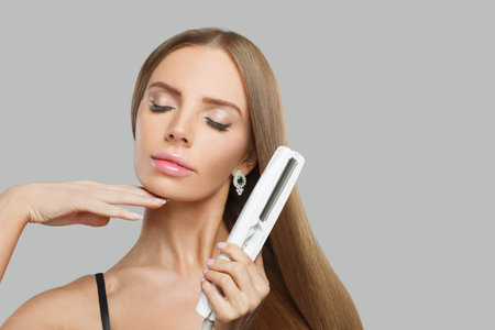Beautiful model. Woman with long brown hair, natural makeup and healthy clean skinの写真素材