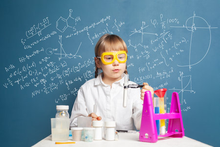 School student girl doing science experiment in classroomの写真素材