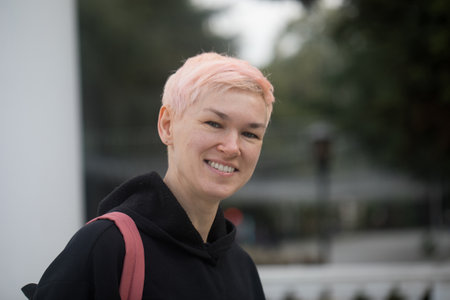 Beautiful mature woman with short hair walking in the cityの写真素材