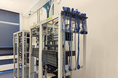 Racks and network cables in high-tech office. Infrastructure, networking, and data storage conceptの写真素材