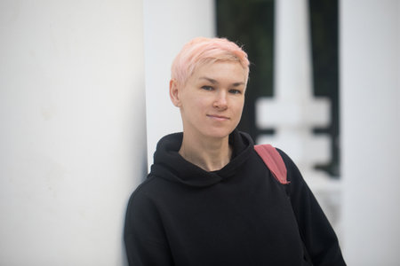 Friendly middle-aged woman with short hair outdoorsの写真素材