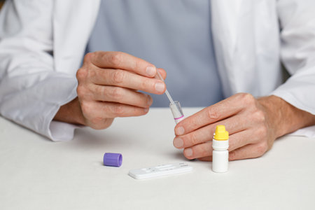 Male veterinarian practitioner doing medical sample rapid diagnostic test at examination room. Rapid...