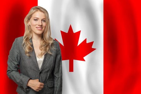 Blond happy woman with flag of Canadaの写真素材