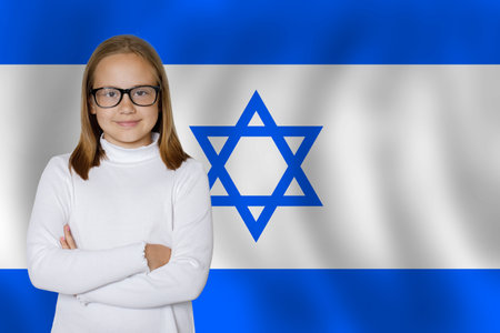 Cute young girl on Israeli flag background. Education and childhood in Israel conceptの写真素材