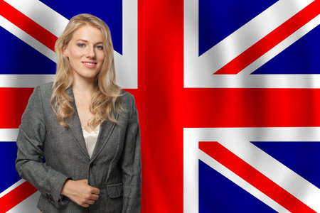 Confident happy woman with flag of UKの写真素材