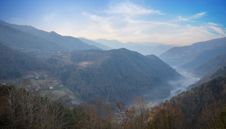 Sunny landscape of mountains, river and trees in Variaki, Georgiaの写真素材