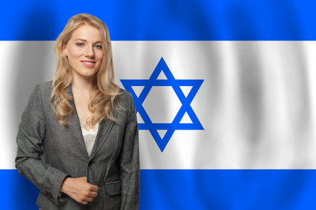 Attractive happy woman with flag of Israelの写真素材