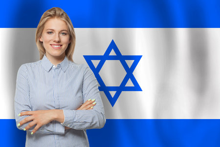 Beautiful happy woman with flag of Israelの写真素材