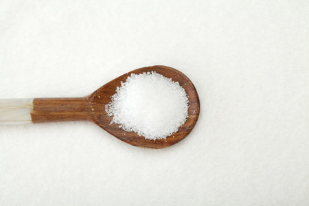Wooden spoon with salt, top view backgroundの写真素材