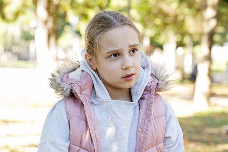 Tired young girl outdoors, portrait