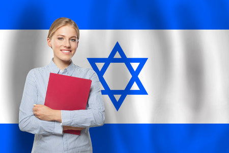 Young happy woman with flag of Israelの写真素材
