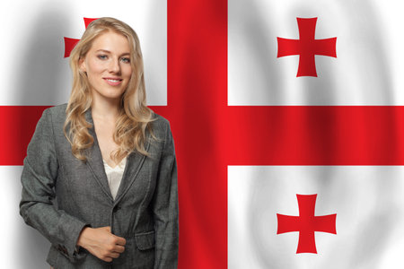 Successful happy woman with flag of Georgiaの写真素材