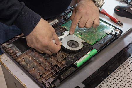 Technician repairing laptop computer closeupの写真素材