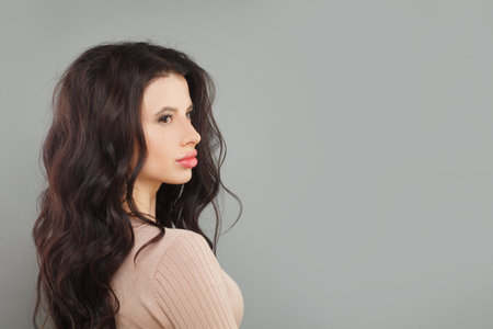 Perfect model woman posing on gray background, fashion portraitの写真素材