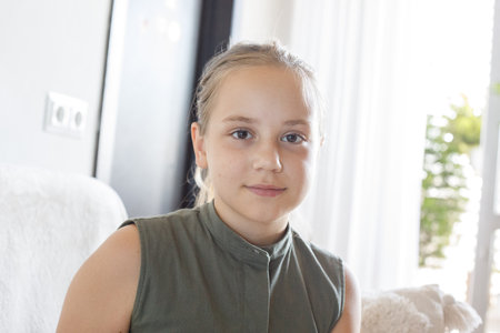 Cute child girl sitting at home, indoor portrait