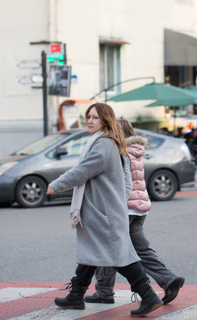 Mature woman and child crossing the road. Family in the cityの写真素材