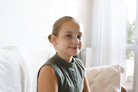 Happy child girl sitting at home, indoor portrait