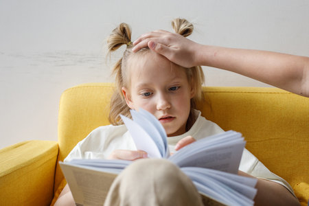 Parent hand on head of child girlの写真素材