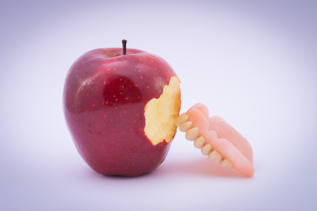 Dental prothesis meets appleの写真素材