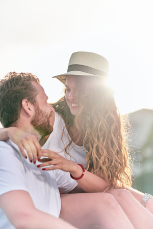 Couple sitting and enjoying at beachの写真素材
