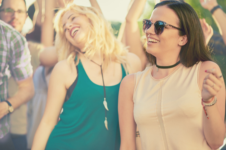 Crowd of people at music festival dancing and enjoying musicの写真素材