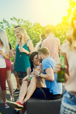 Couple flirting at outdoor partyの写真素材