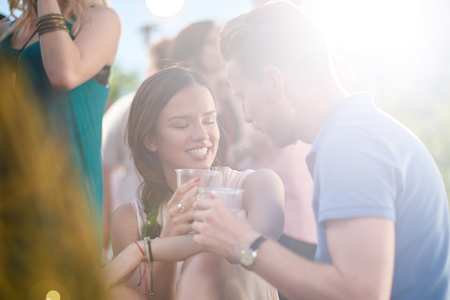 Couple flirting at outdoor partyの写真素材