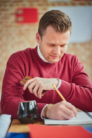 Portrait of a young designer/architect/businessman at work in his home officeの写真素材