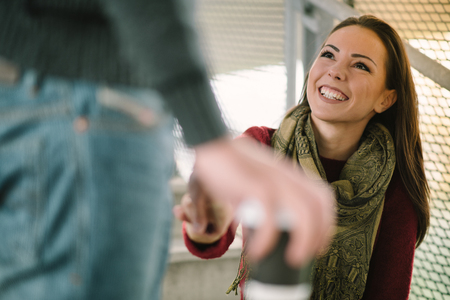 Mixed race couple embracing, smiling and enjoyingの写真素材