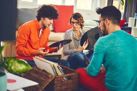 Group of friends listening music - vinyl at homeの写真素材