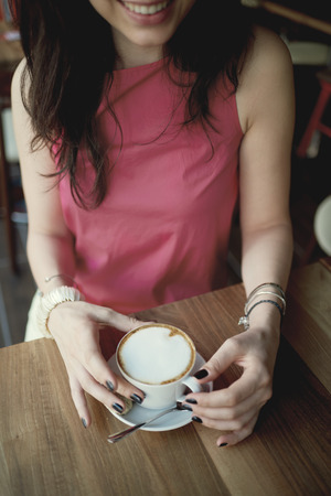Aerial view of girl drinking coffee in cafeの写真素材