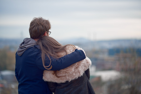 Couple hugging and looking at the horizon at the autumn. Back turnedの写真素材