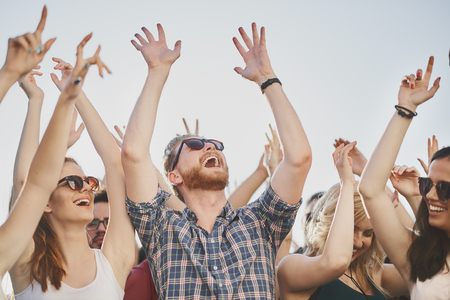 Group of people dancing and having a good time at the outdoor party/music festivalの写真素材